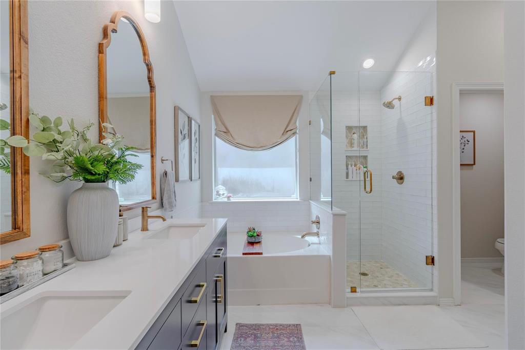 a bathroom with a granite countertop sink a shower and a mirror