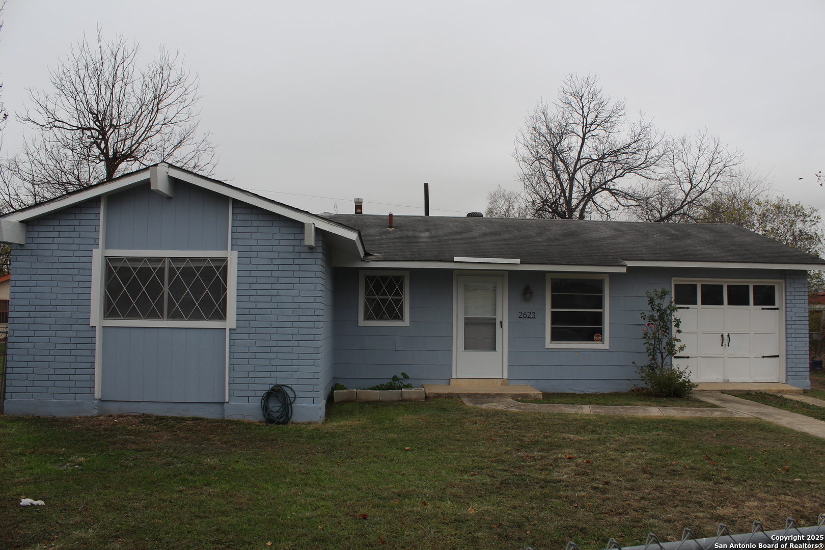 a front view of a house with a garden