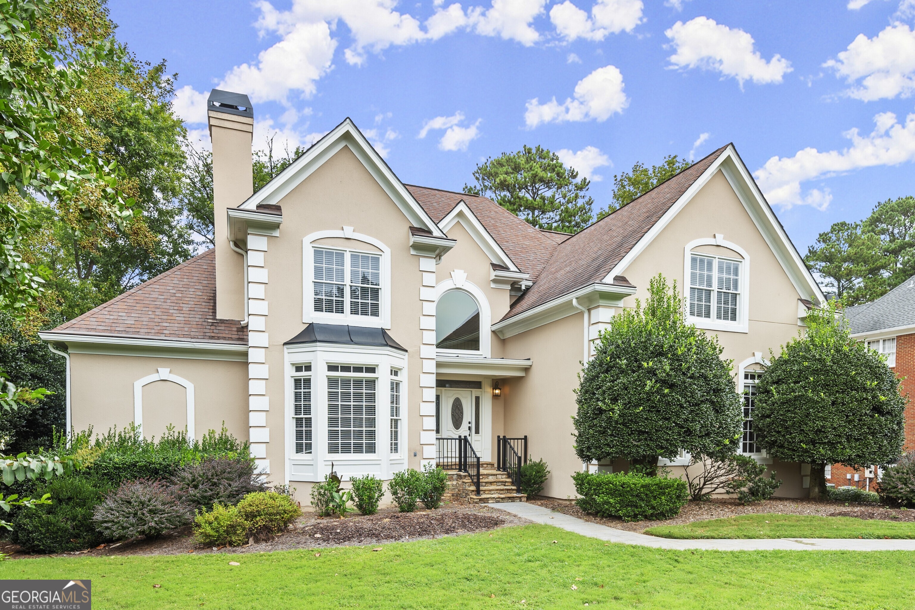 a front view of a house with garden