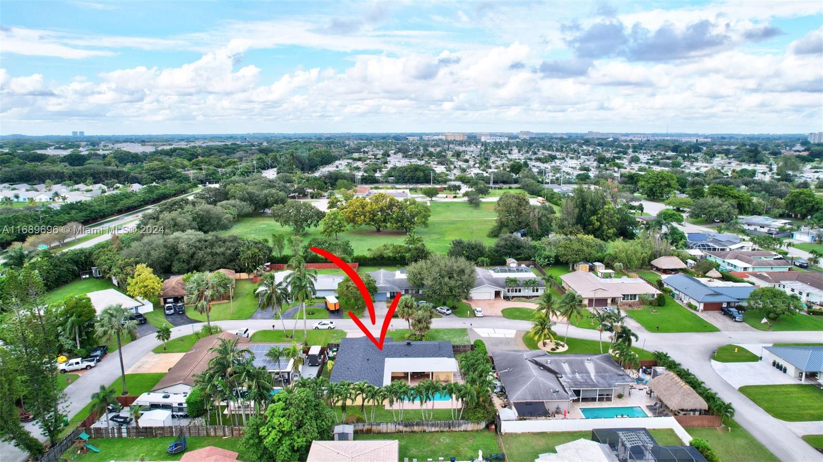 an aerial view of residential houses with outdoor space and swimming pool