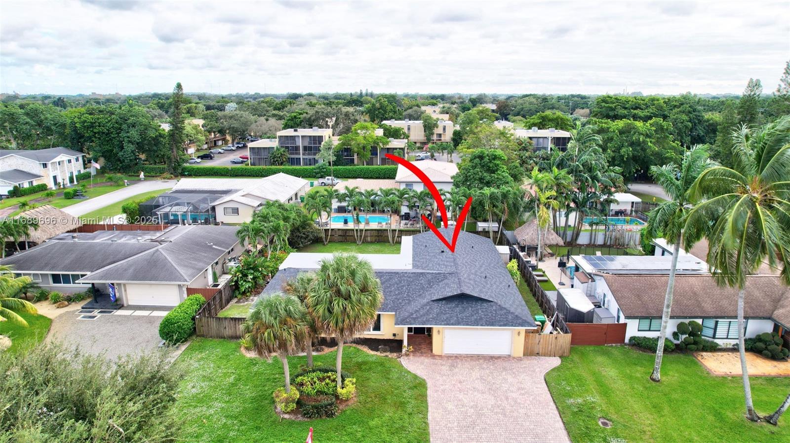 an aerial view of a house with yard swimming pool and outdoor seating