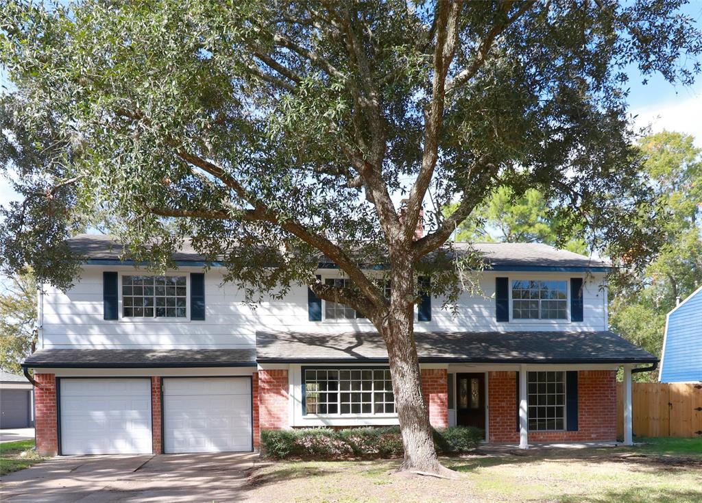 a front view of a house with a tree