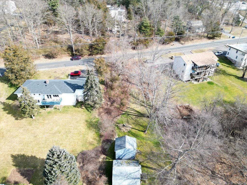 a view of yard along with trees and a wooden fence