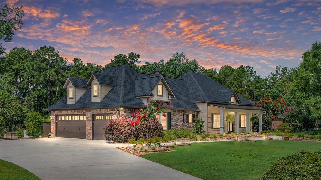 a front view of a house with a garden and trees