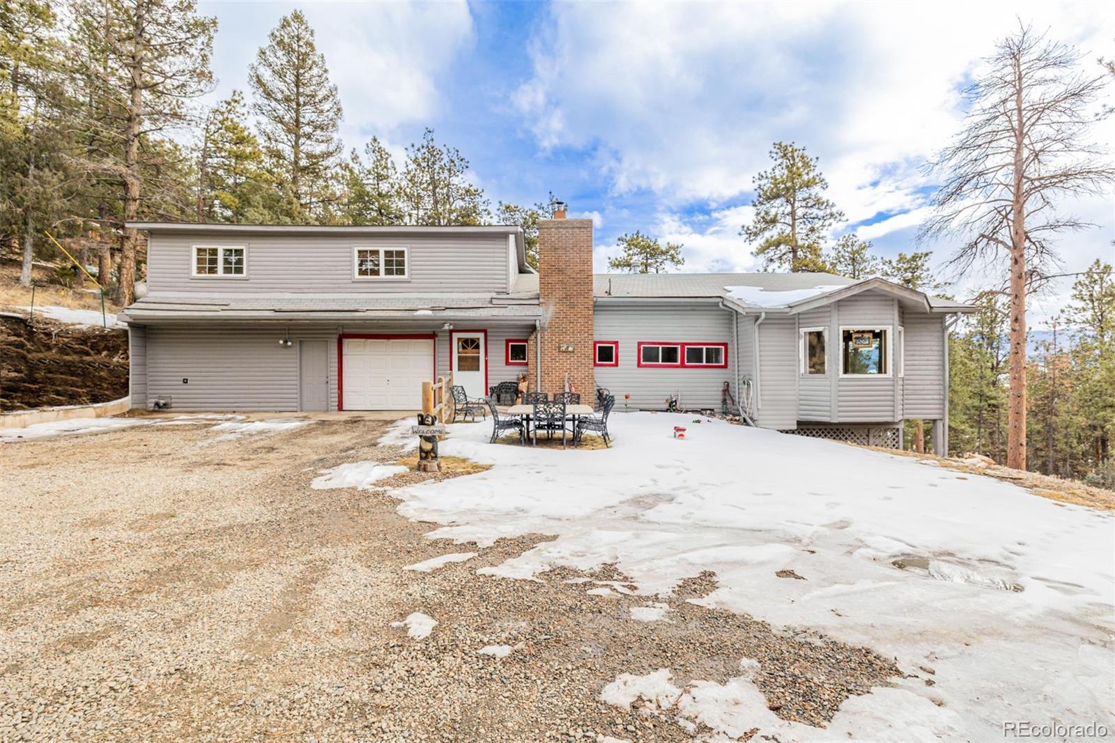 a front view of a house with a snow on the road