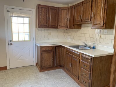 a kitchen with stainless steel appliances granite countertop a sink and a stove