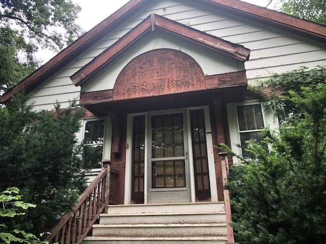 a front view of a house with a garden