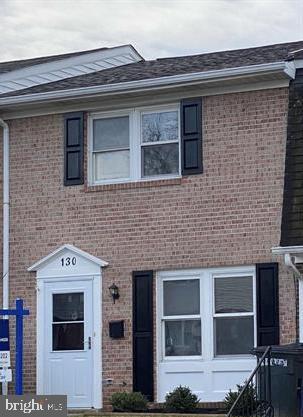 a front view of a house with a large window