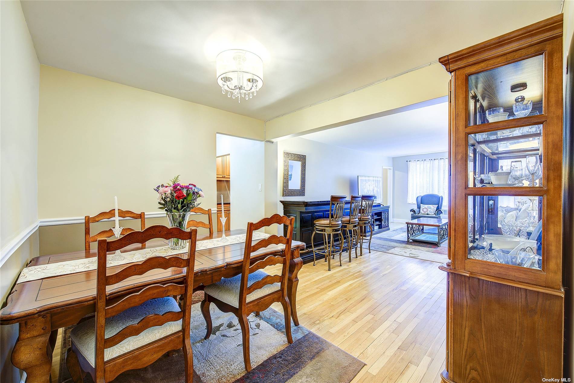 a view of a dining room with furniture and a chandelier