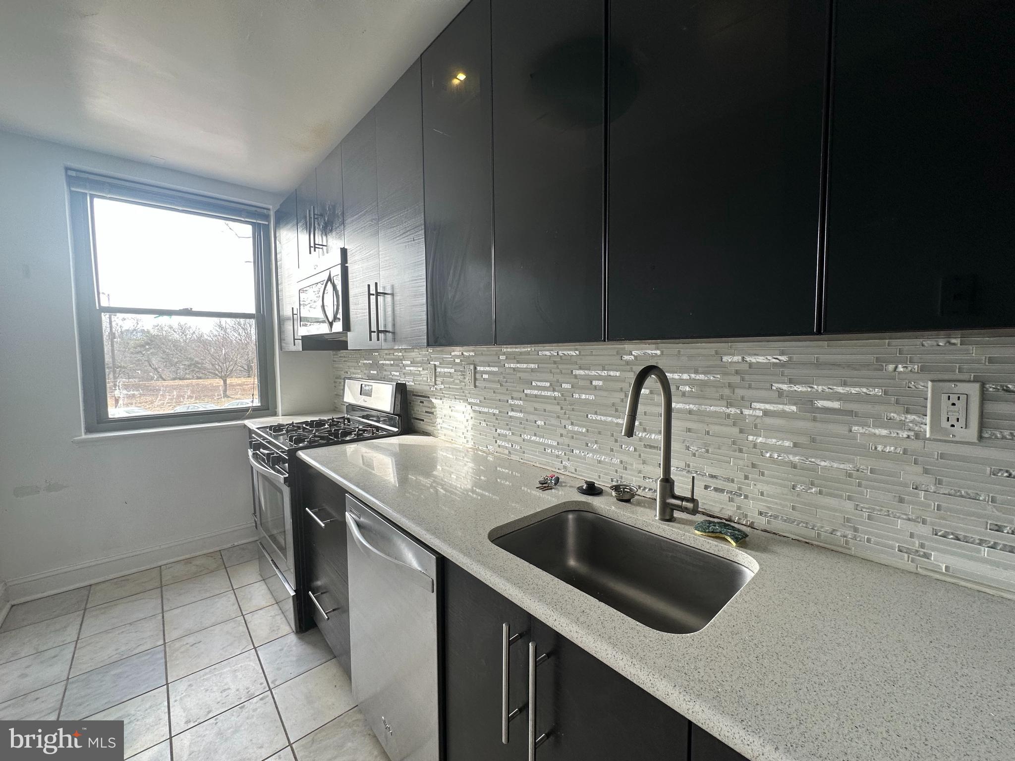 a kitchen with a sink stove and cabinets