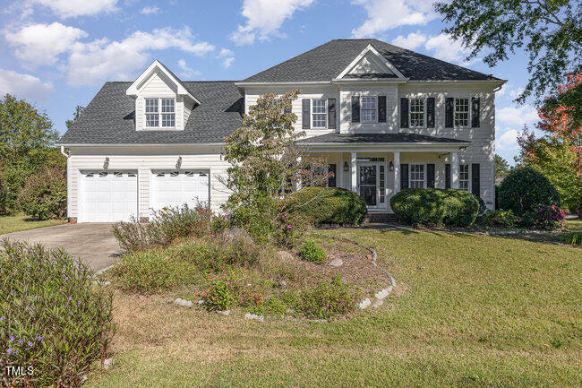 a front view of a house with a garden