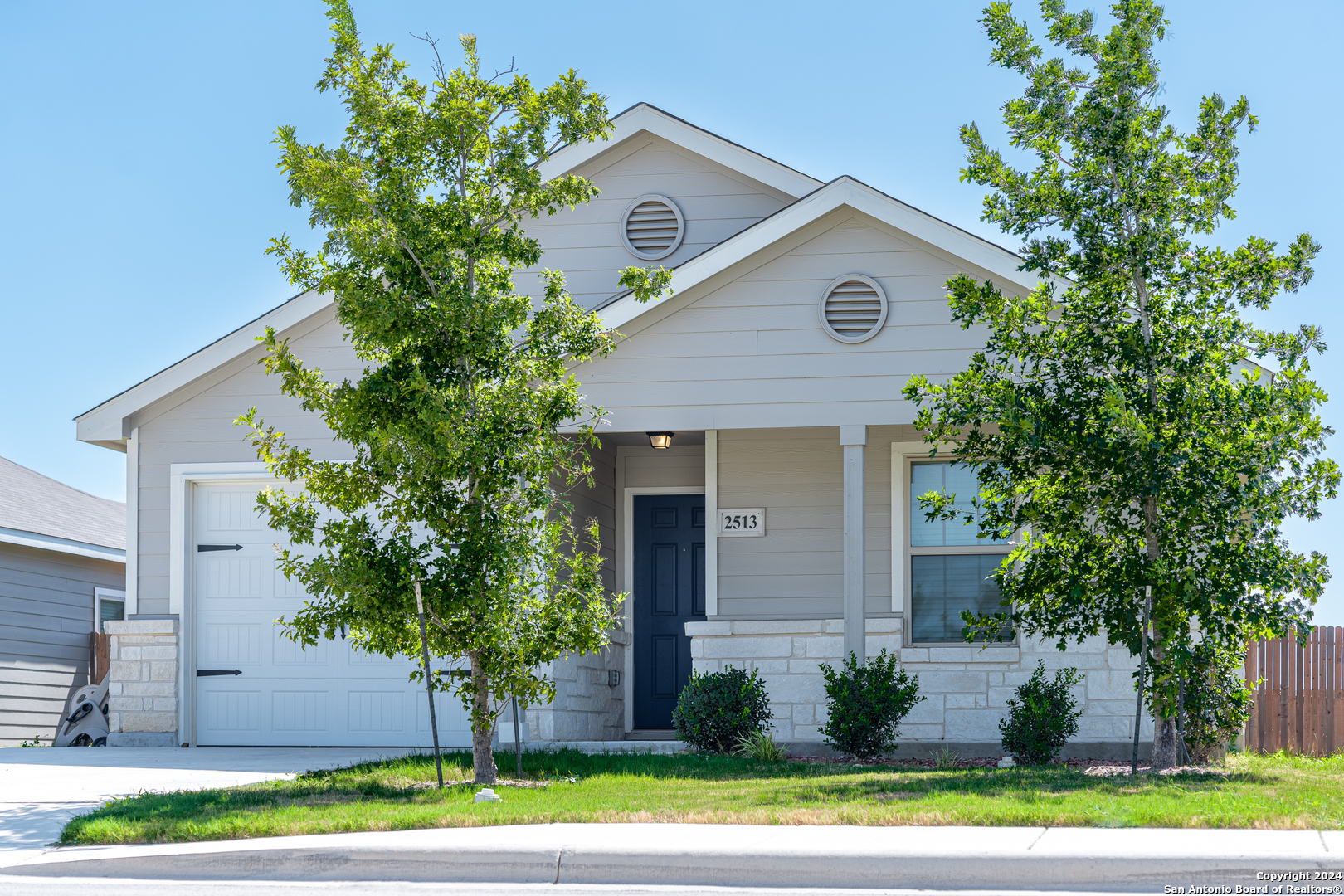 a front view of a house with a yard and garage