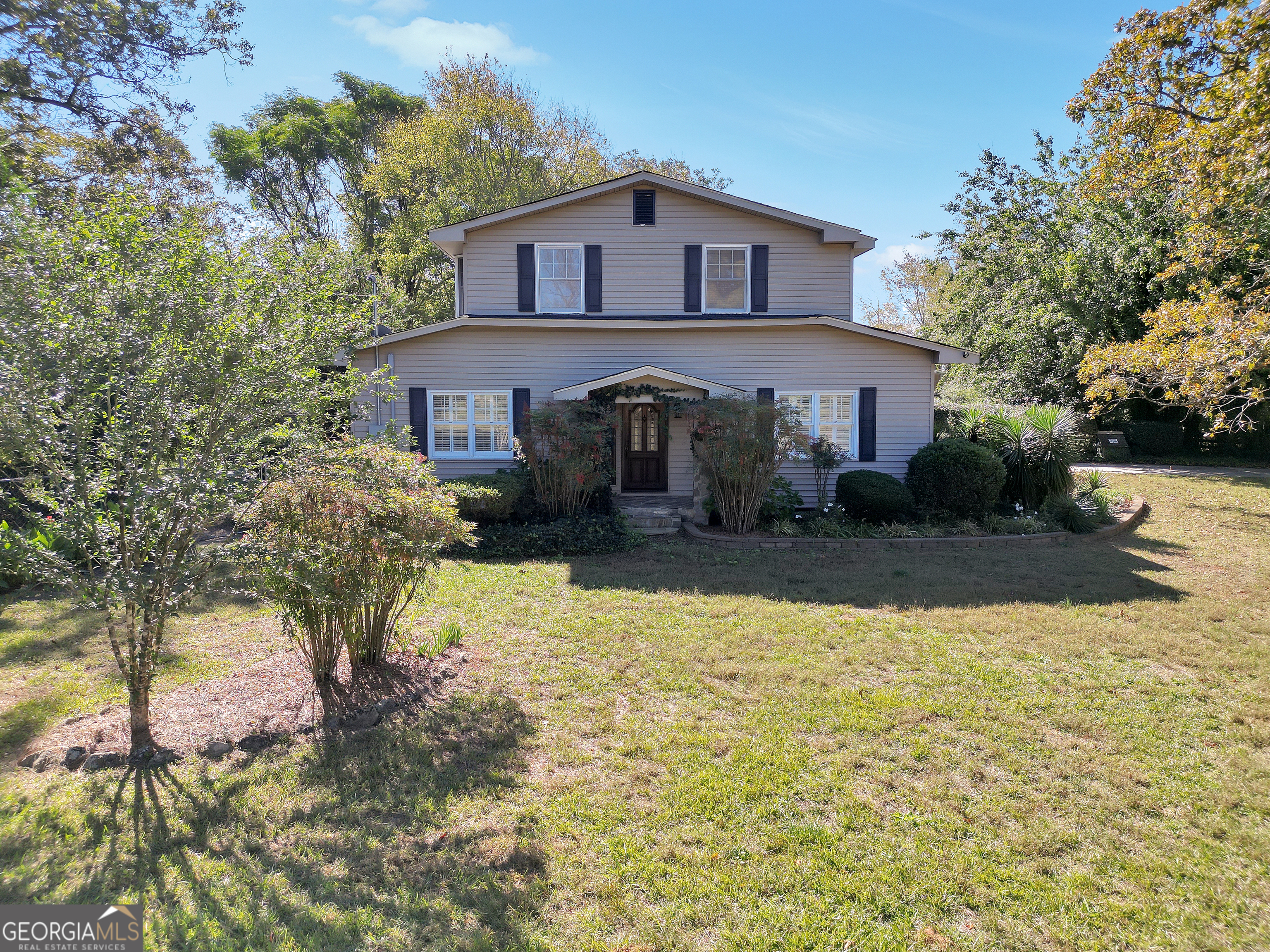 a front view of a house with a yard