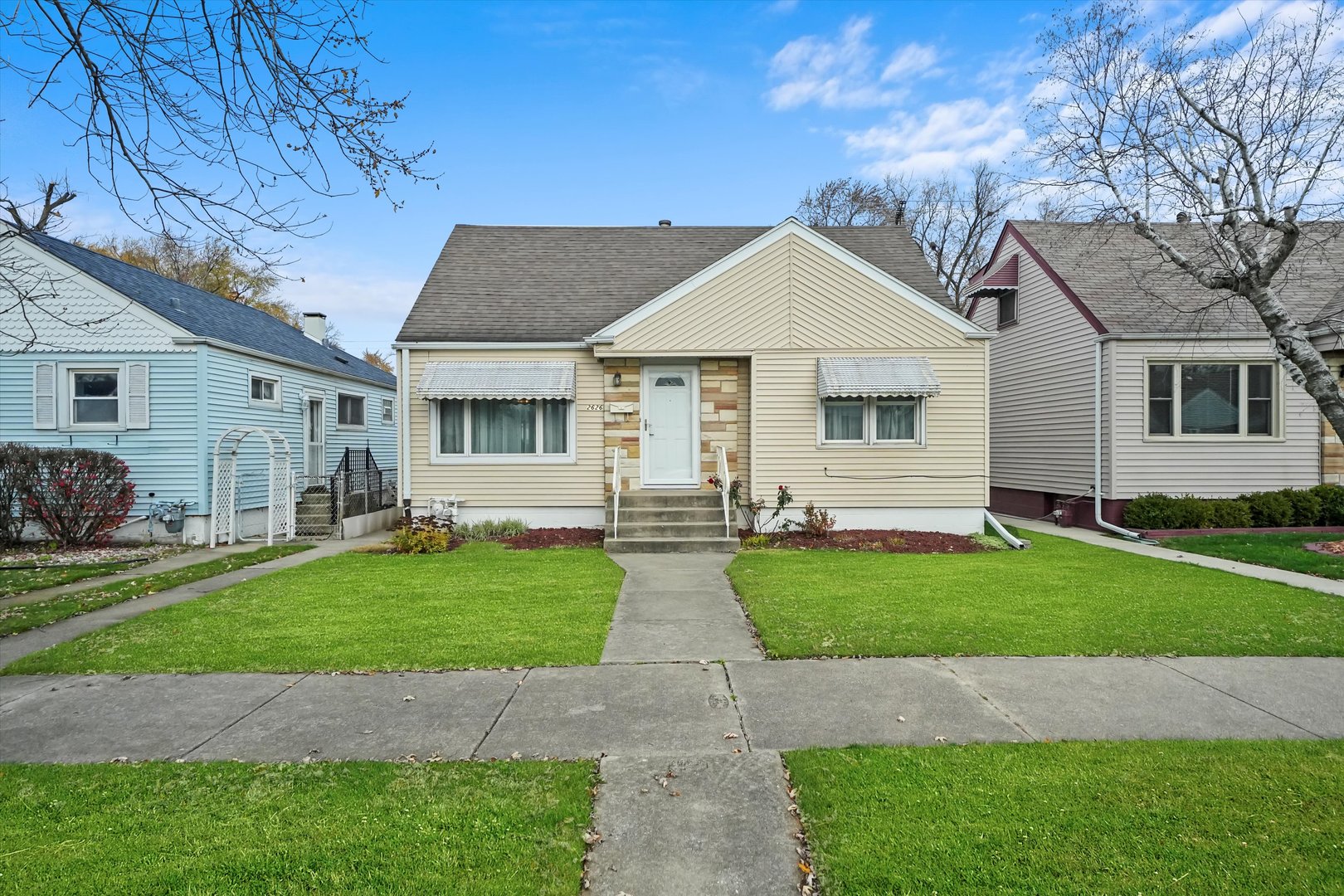 a front view of house with yard and green space