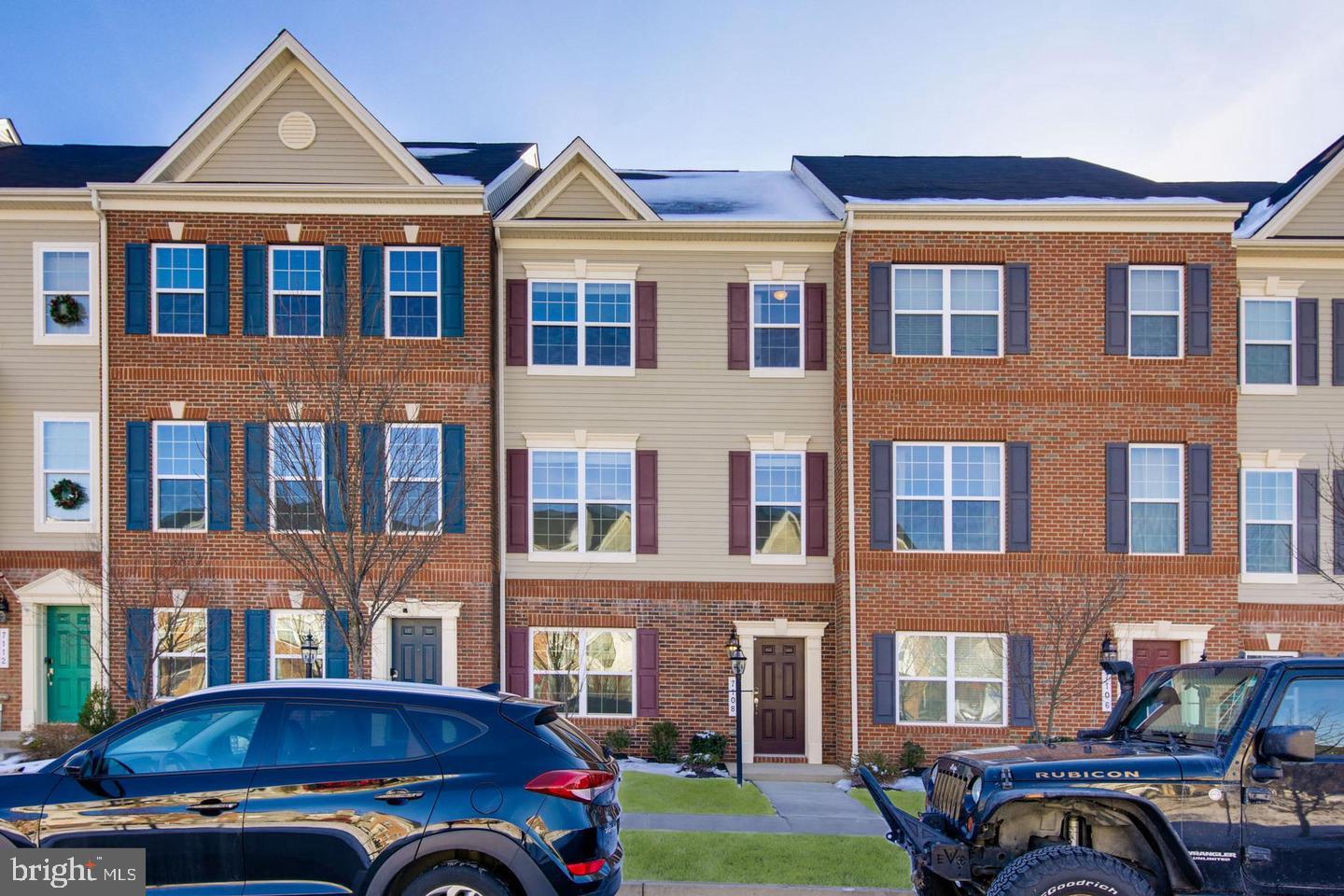 a front view of a residential apartment building with a yard