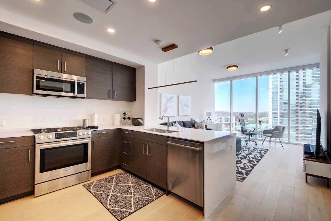 a kitchen with a sink stove and microwave