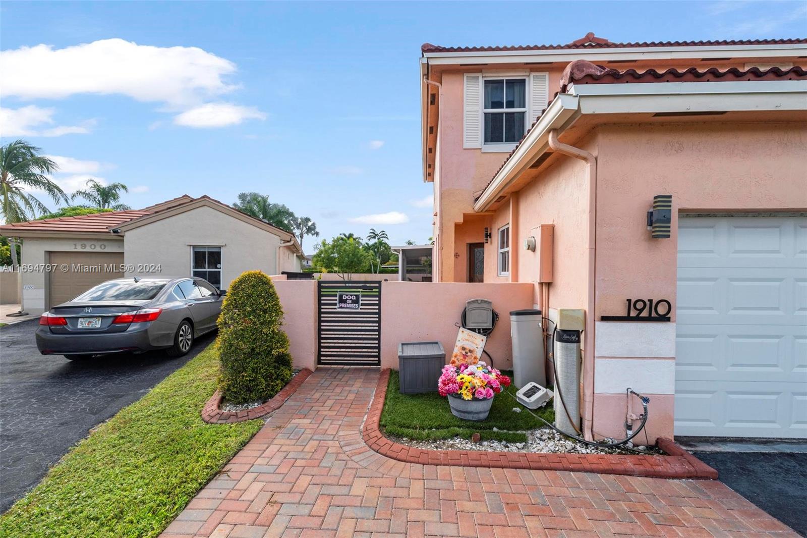 a view of a house with a garden and parking space