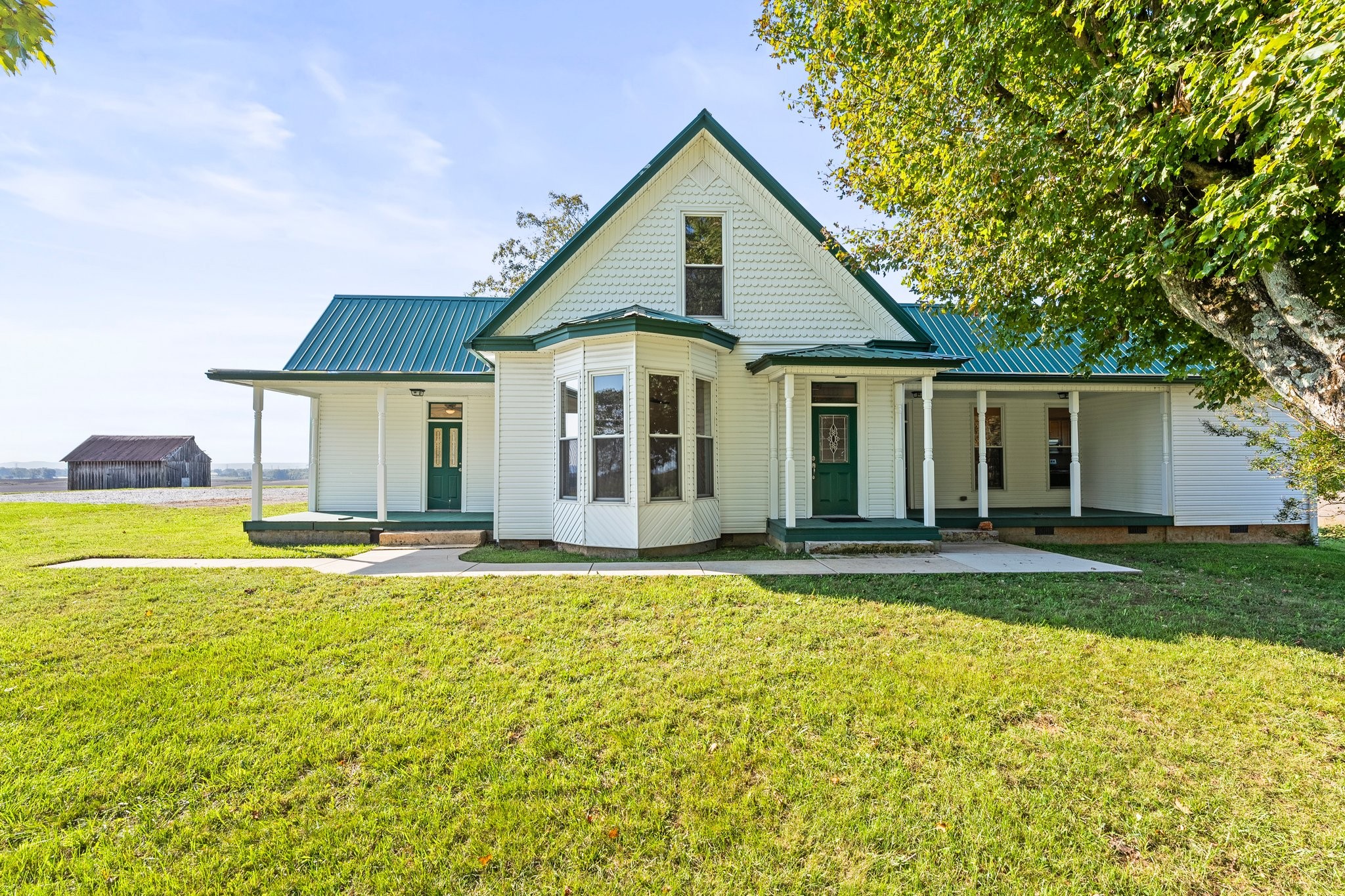 a view of a house with swimming pool and a yard