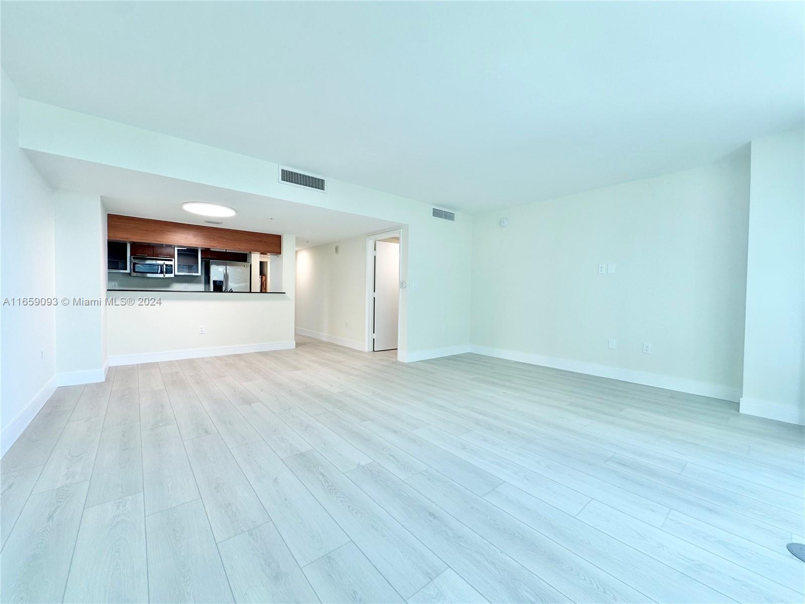 wooden floor in an empty room and a window