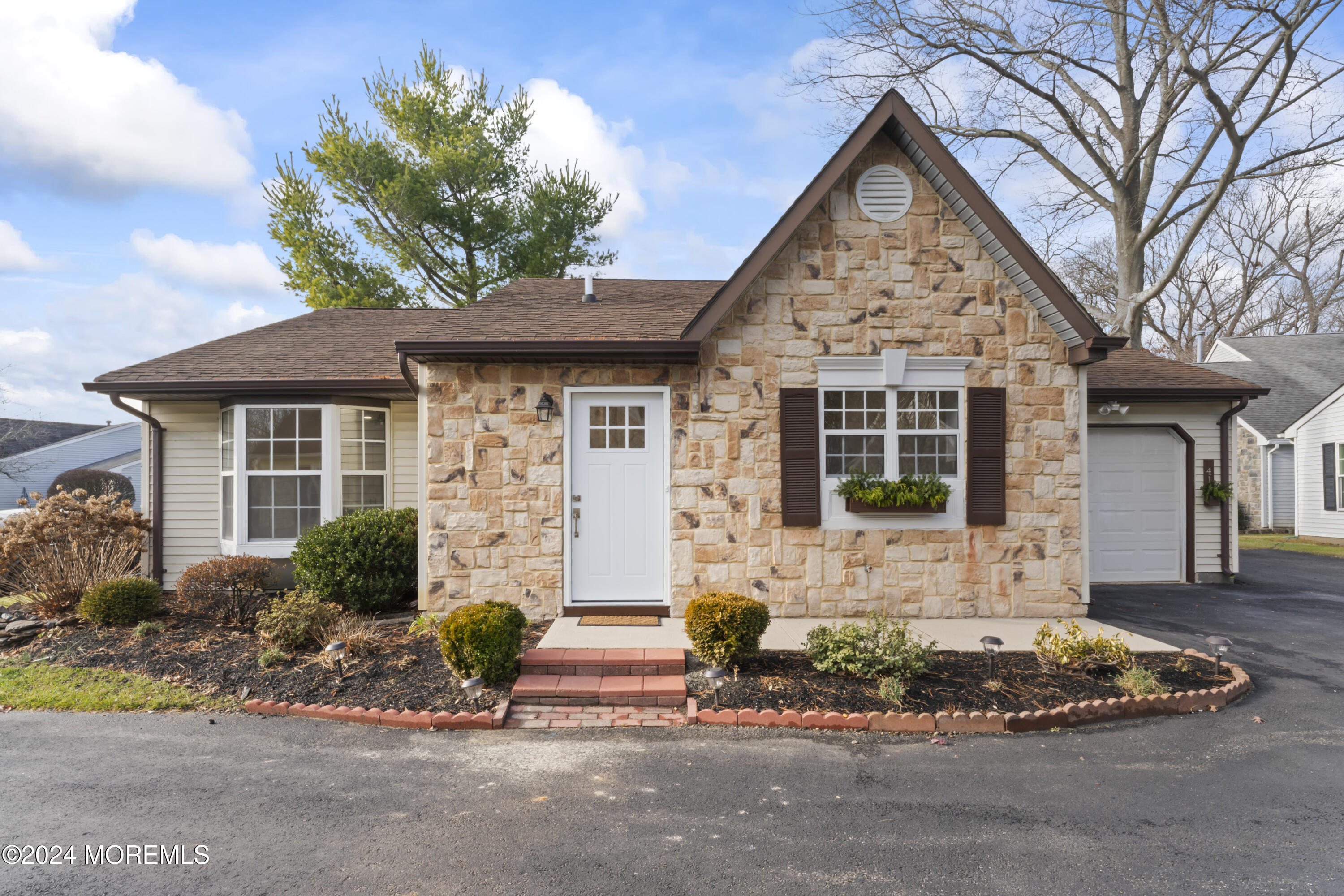 a front view of a house with garden