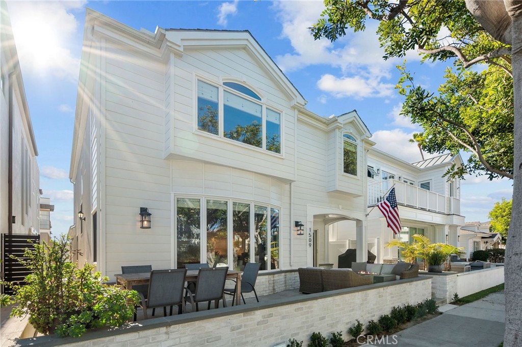 a front view of a house with outdoor seating and plants