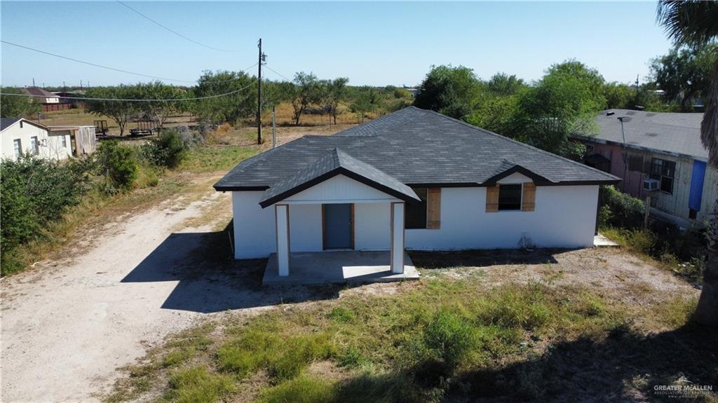 a aerial view of a house with a yard and garage