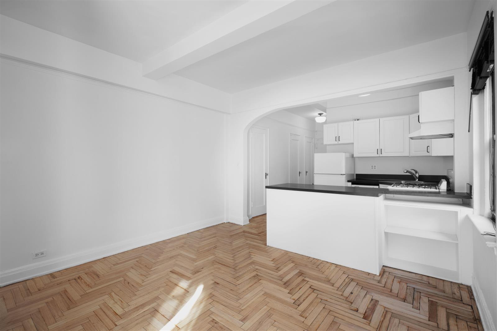 a kitchen with granite countertop white cabinets and white appliances