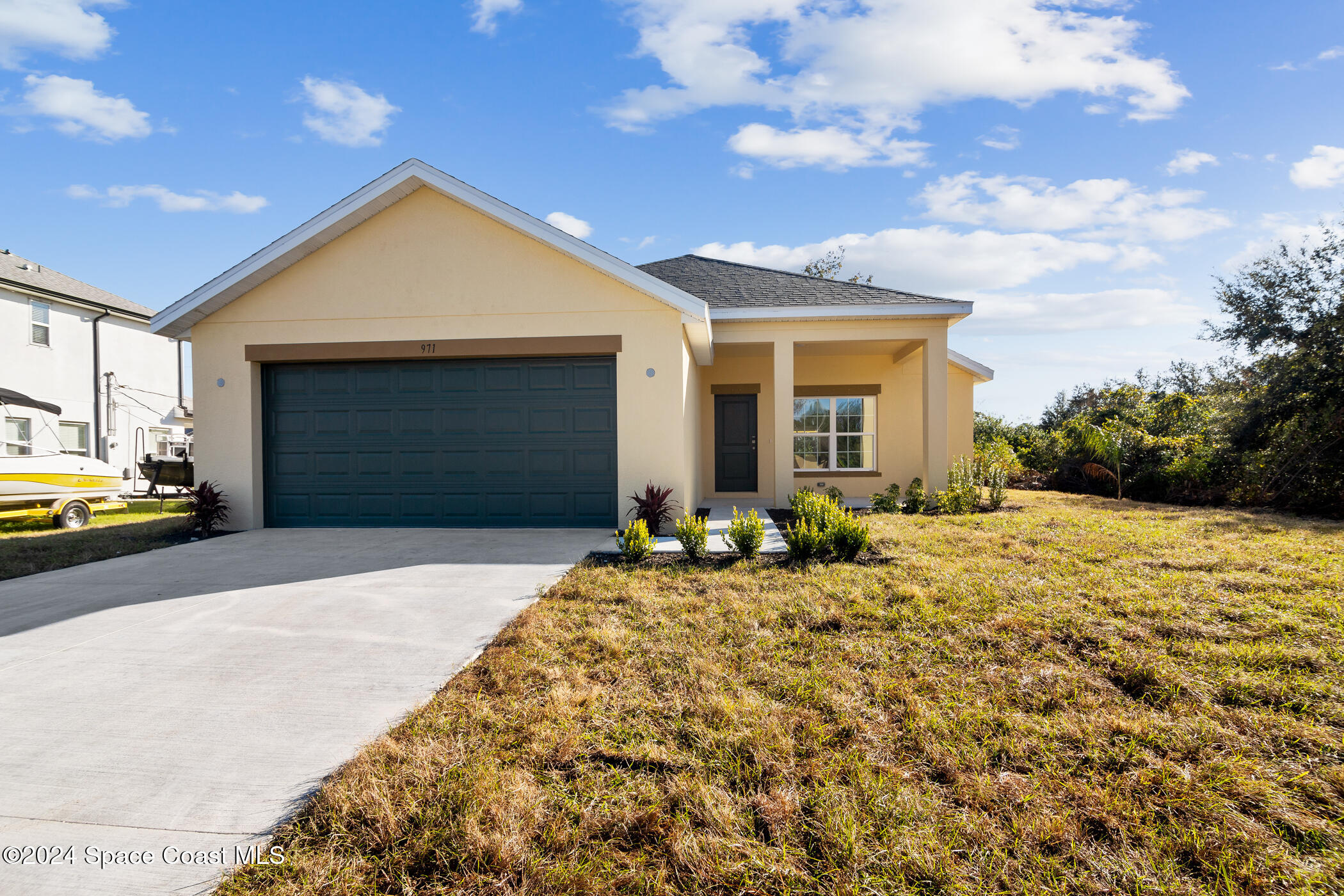 a front view of a house with a yard and garage