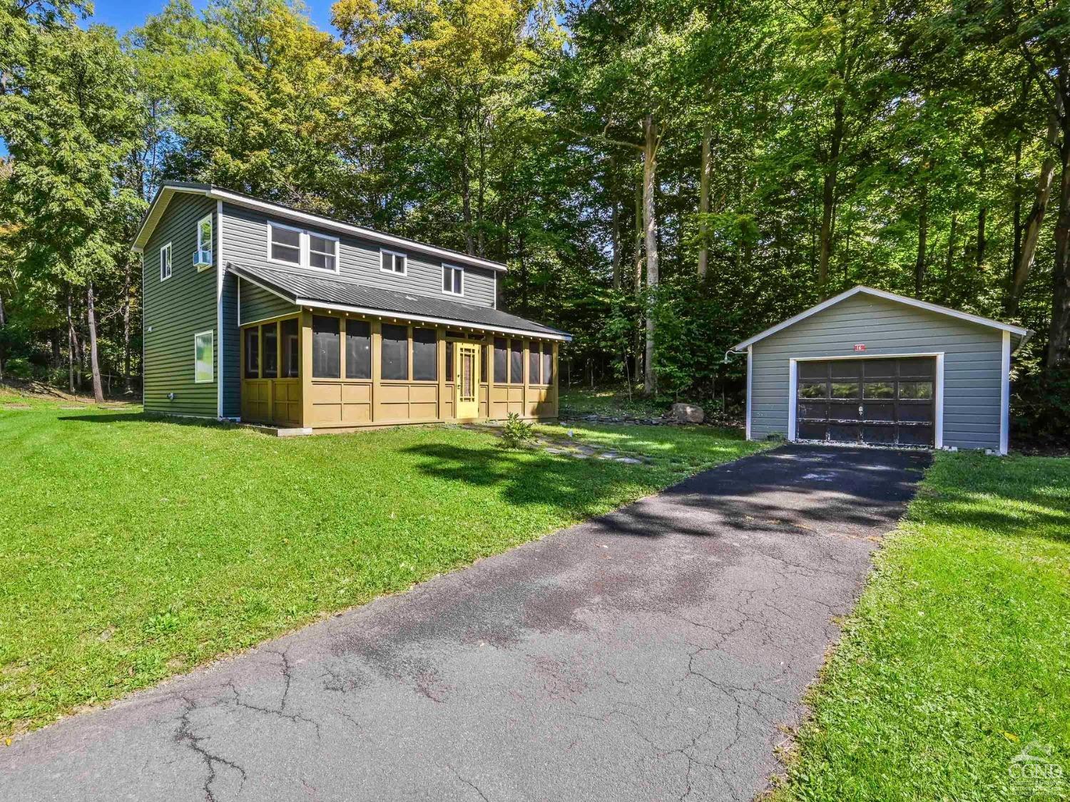 a front view of house with yard and green space