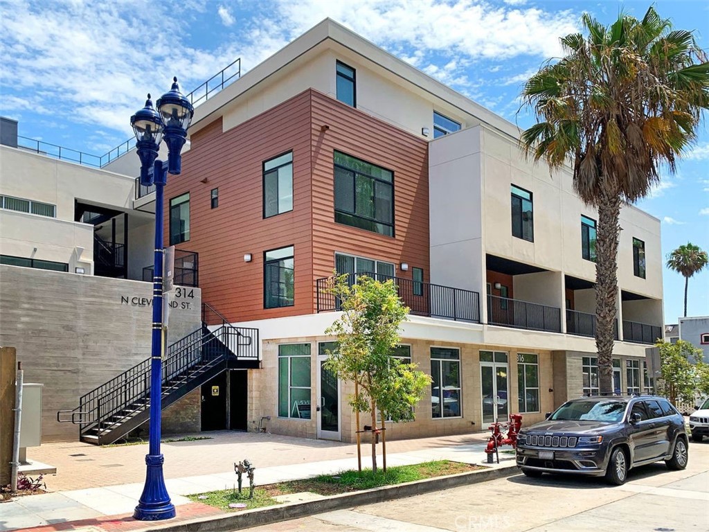 a front view of a building with parking space