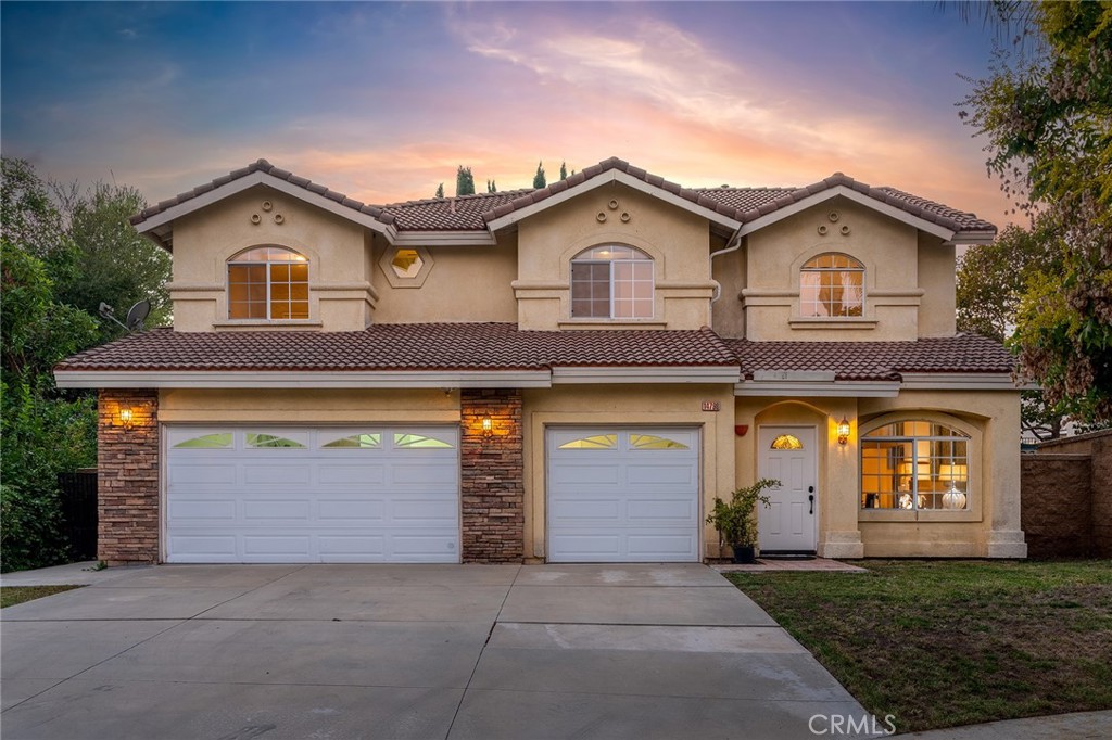 a front view of a house with a yard and garage