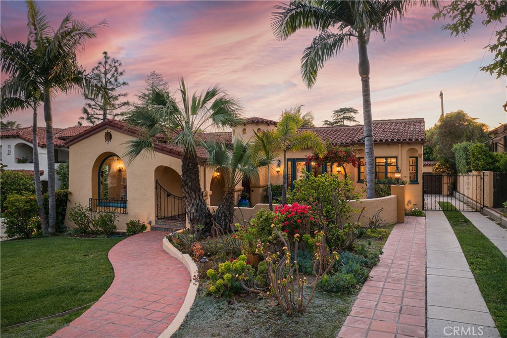 a front view of a house with a garden