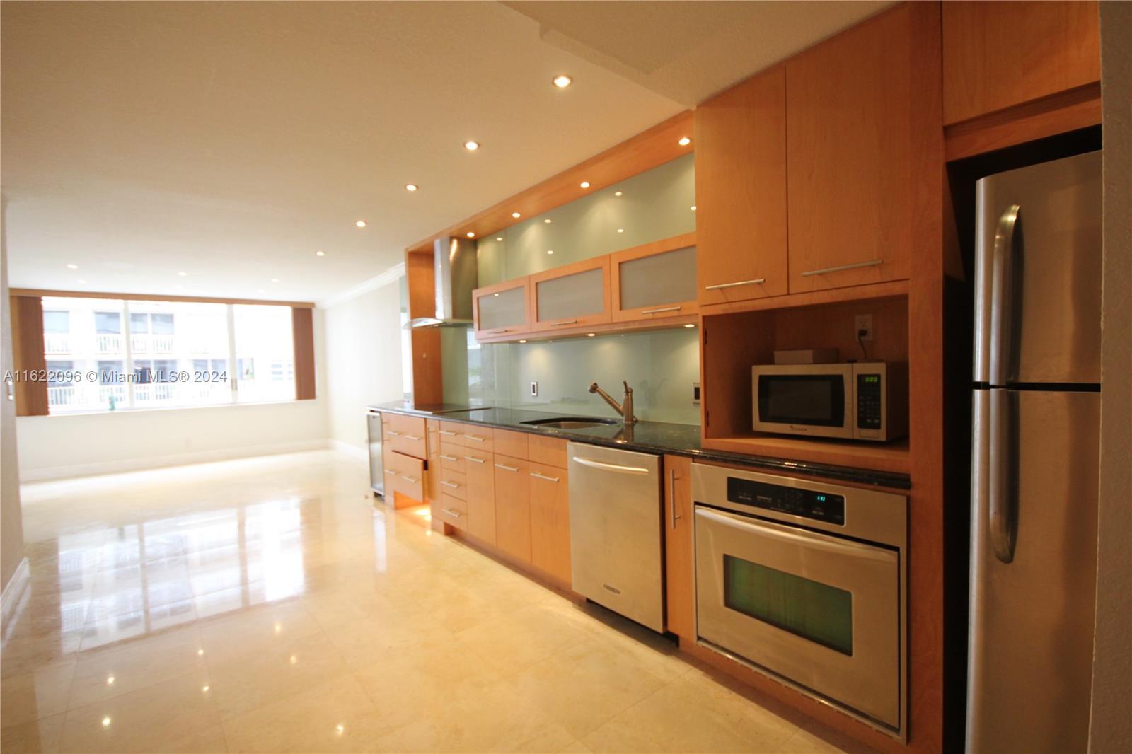 a kitchen with stainless steel appliances a stove sink and microwave