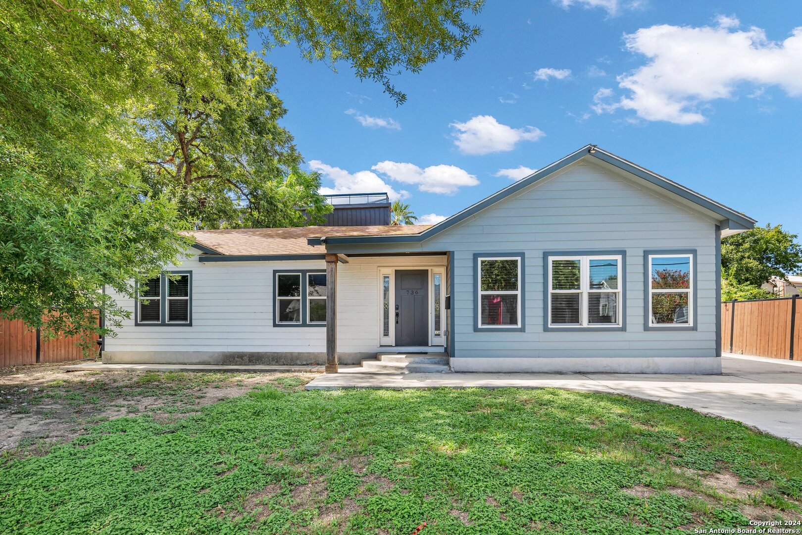 a front view of house with yard and green space