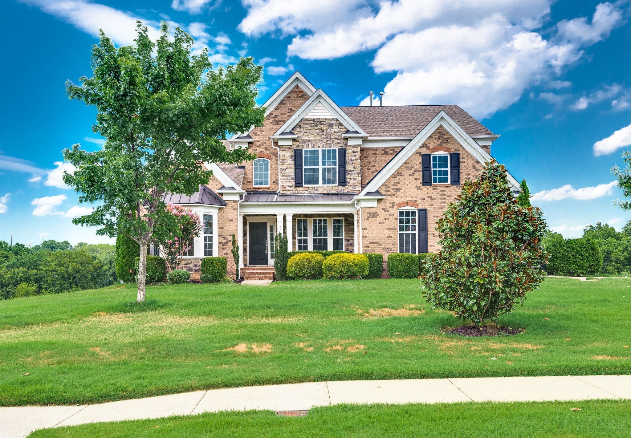 a front view of a house with a garden