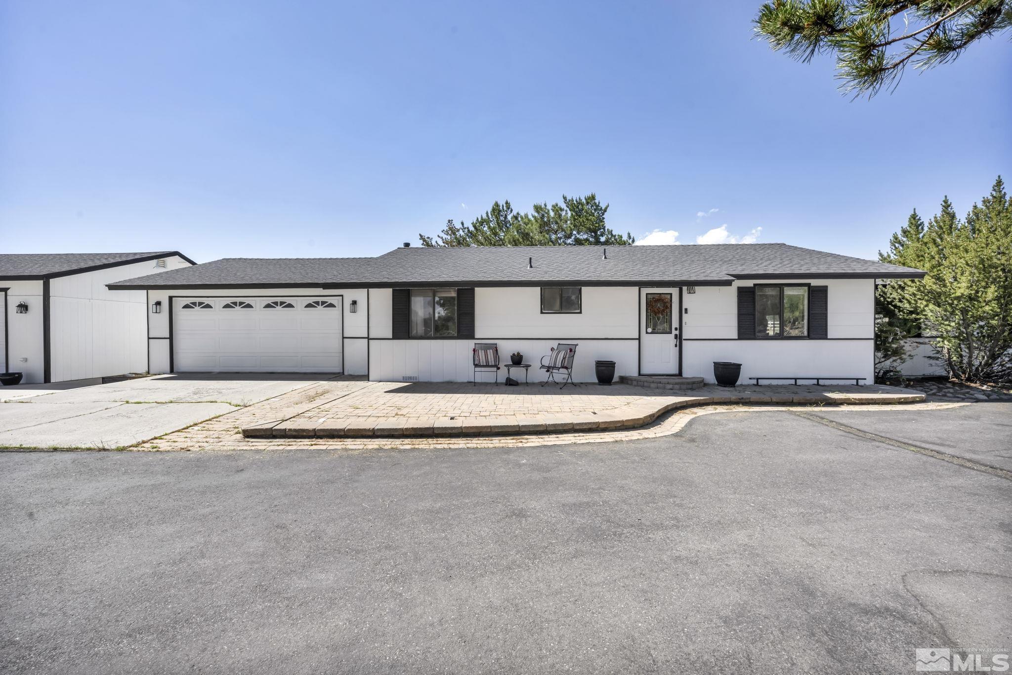 a front view of a house with a yard and a garage