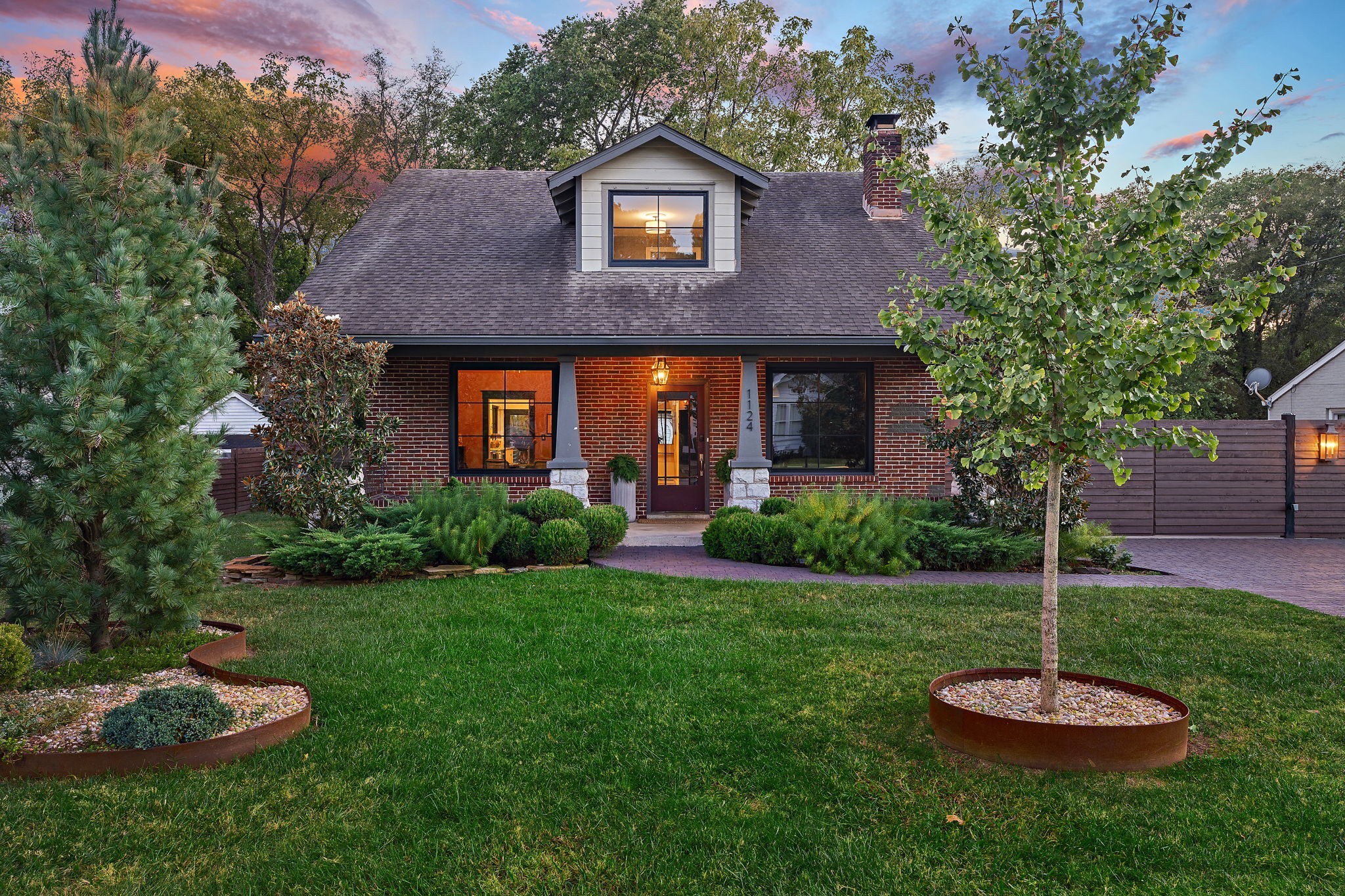 a view of a brick house with a yard