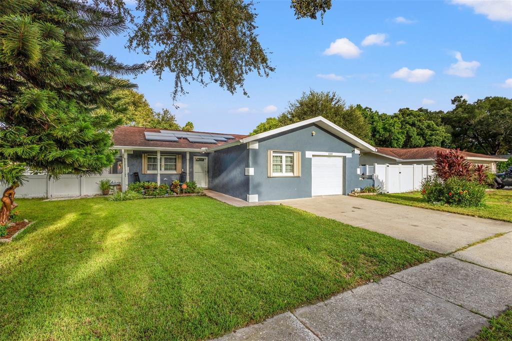 a front view of a house with yard porch and garden