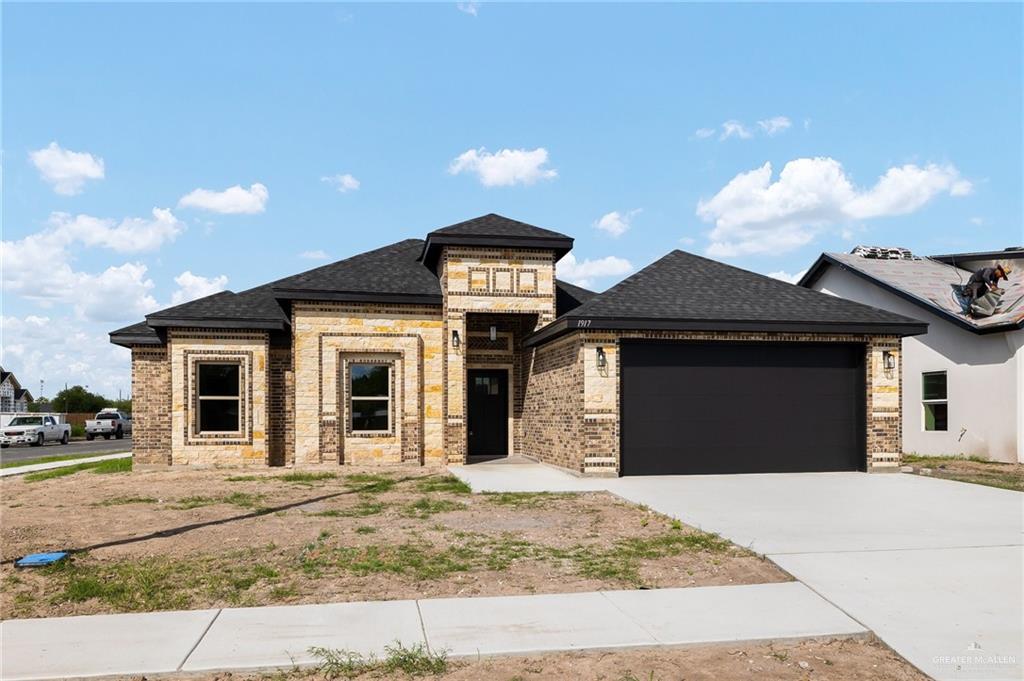 a front view of a house with a yard and garage