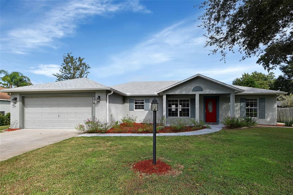 a front view of a house with a yard and garage