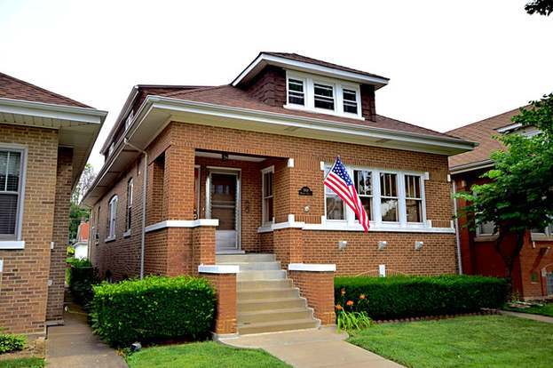 a front view of a house with lots of garden