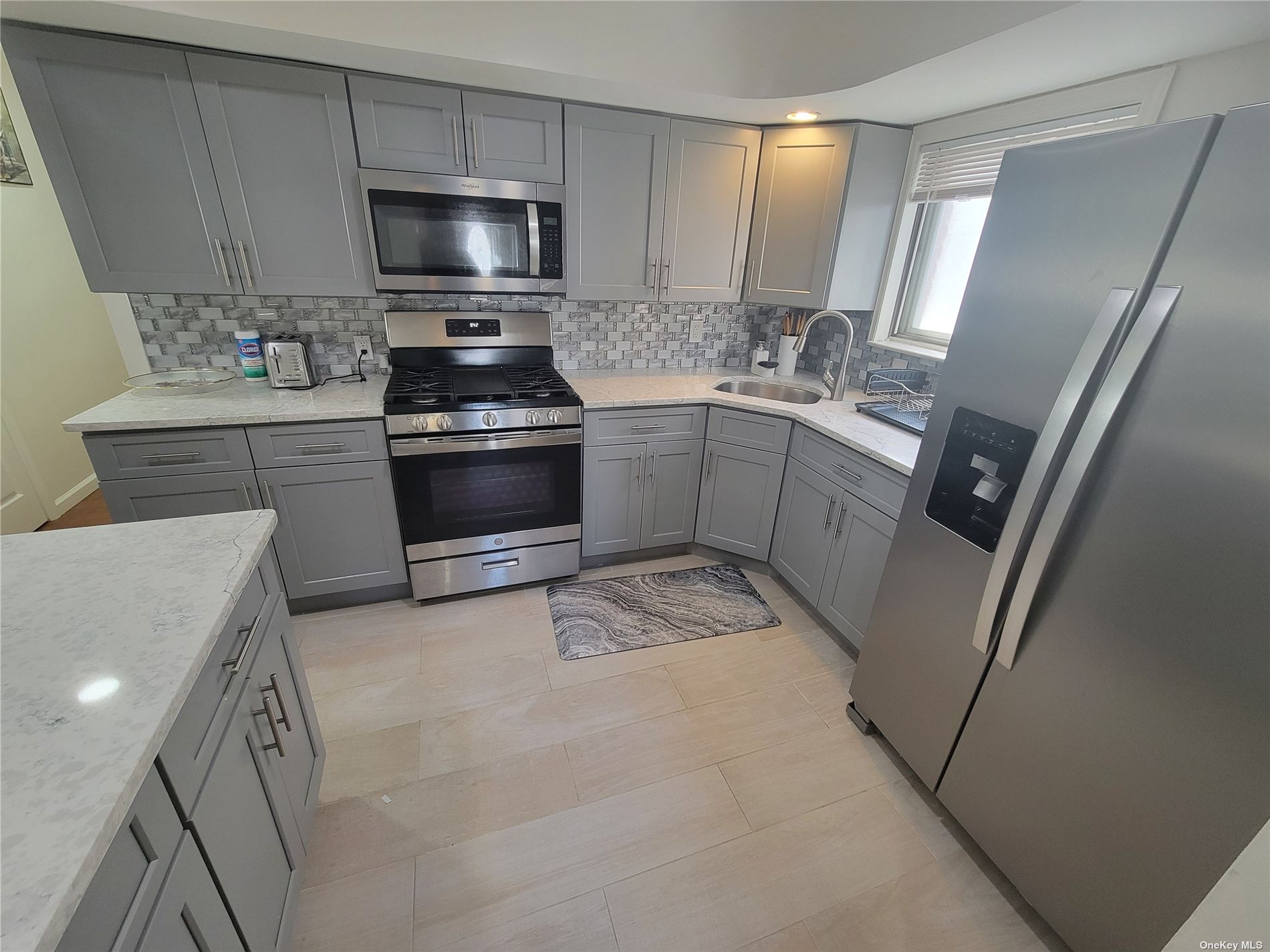 a kitchen with a sink stove and microwave