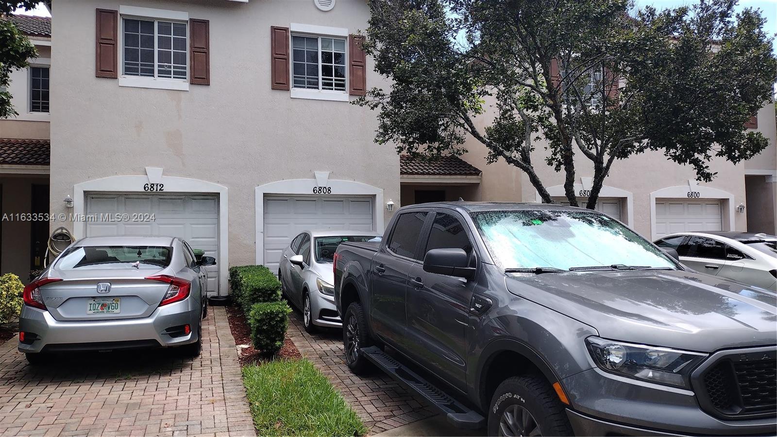 a view of a car parked front of a house