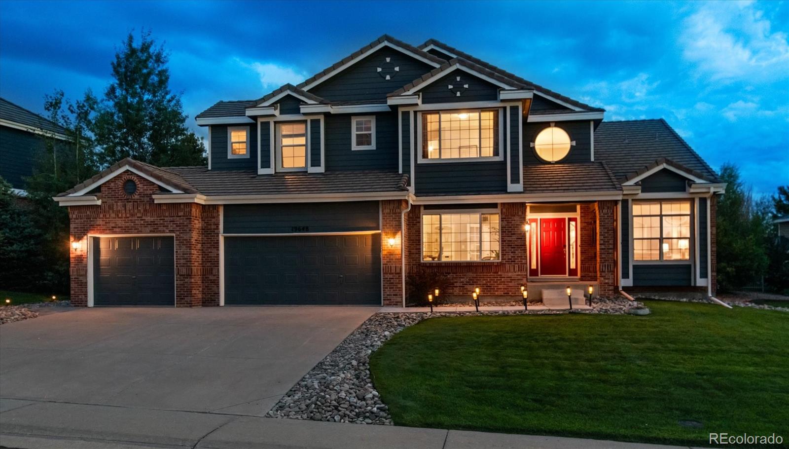 a front view of a house with a yard