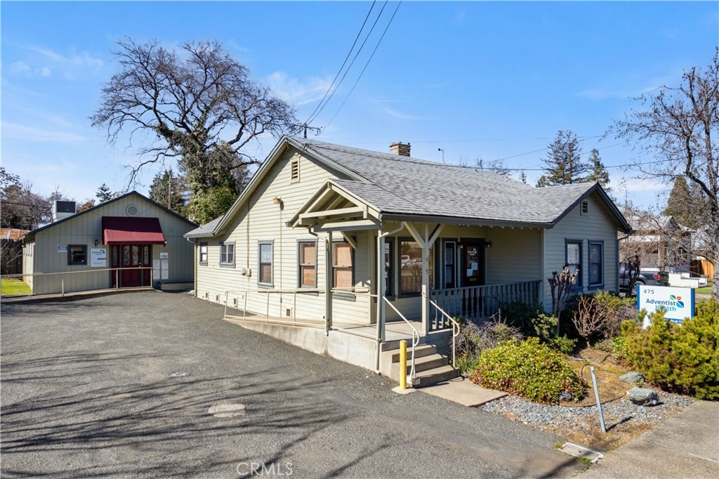 a view of a house with wooden fence