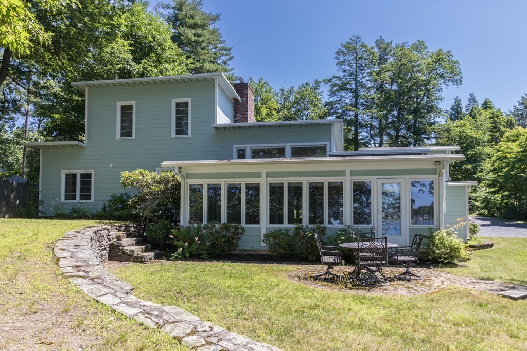 a view of a house with backyard porch and sitting area