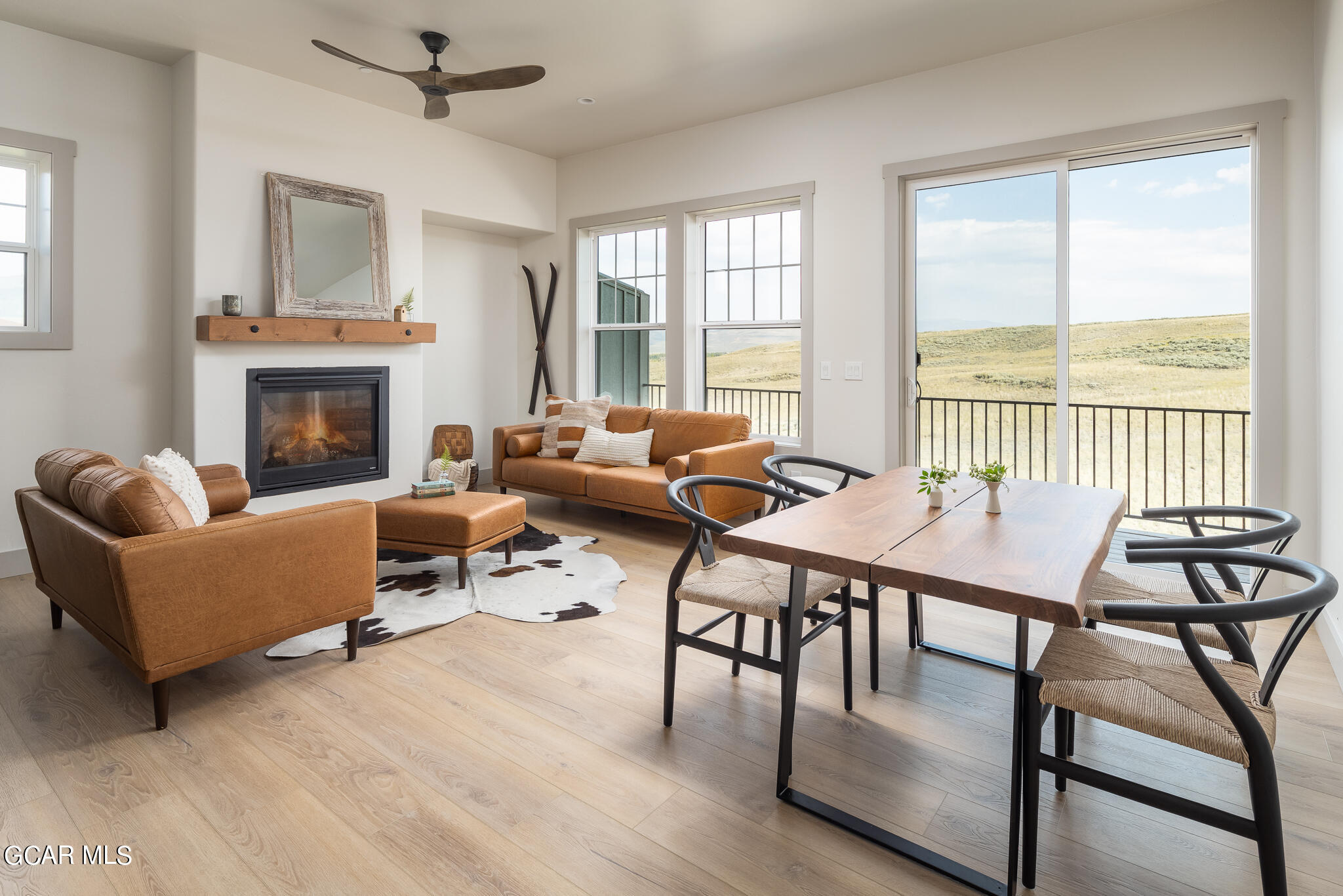 a living room with furniture wooden floor and a fireplace