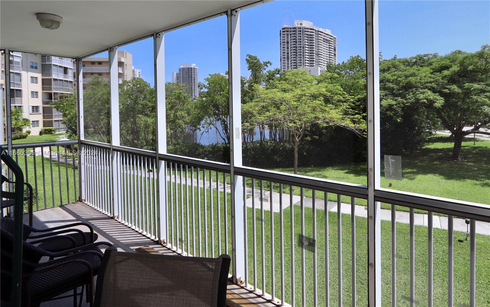 a view of a balcony with floor to ceiling window and wooden fence