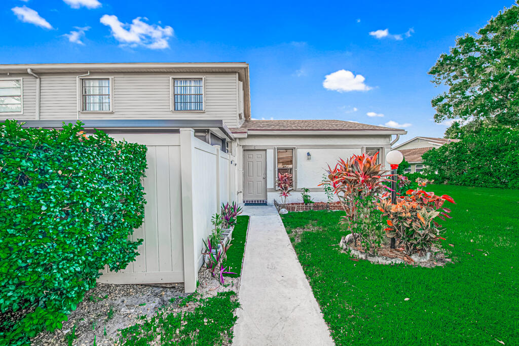 a front view of a house with a yard and flowers