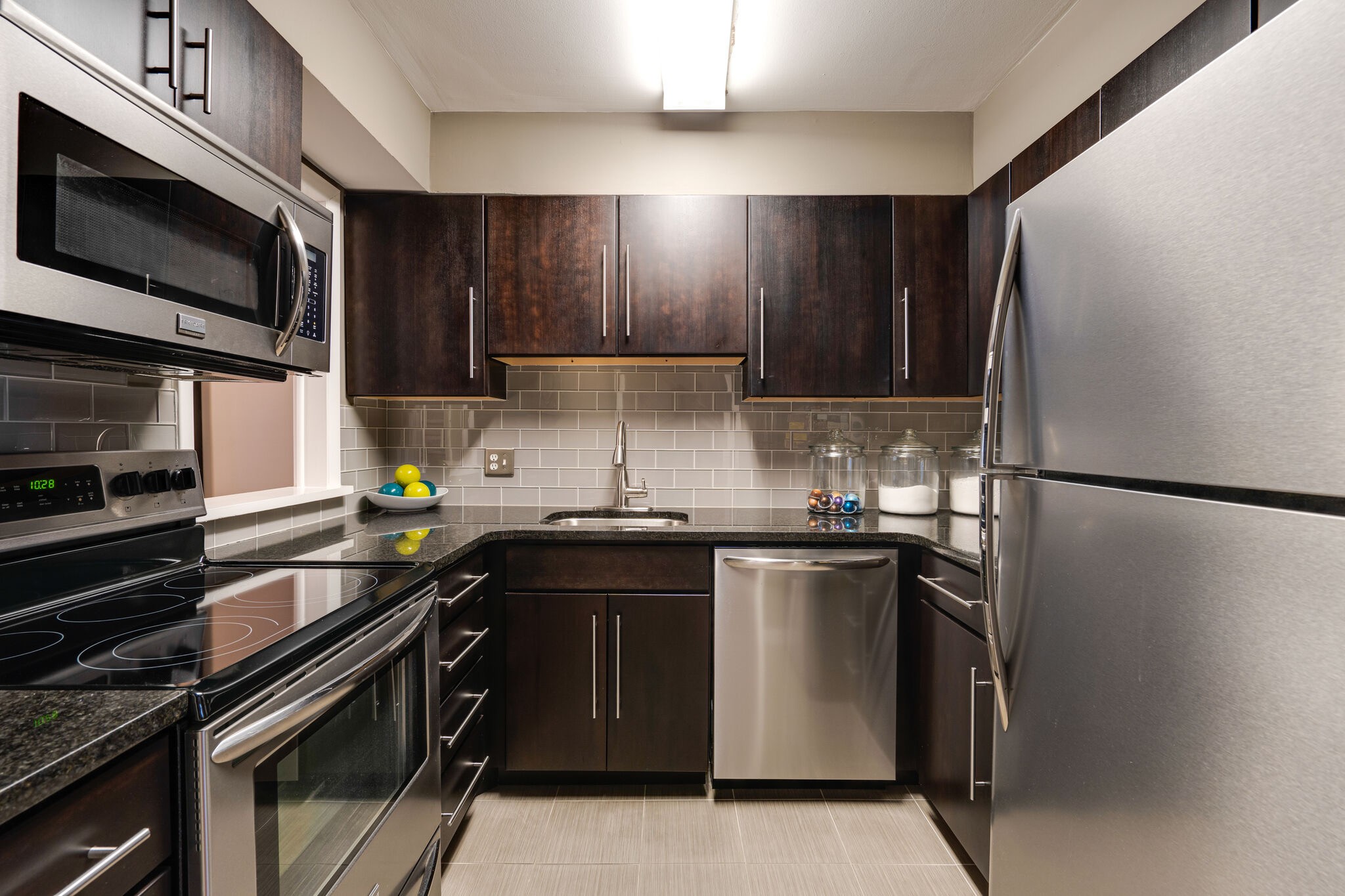 a kitchen with a sink and stainless steel appliances